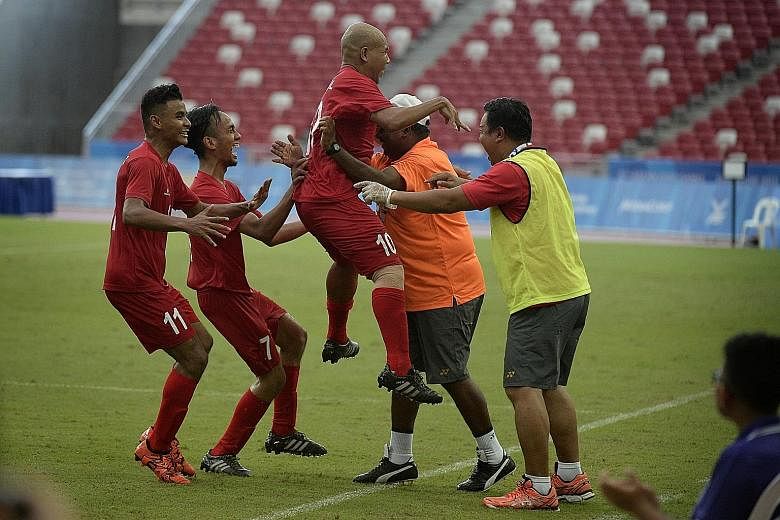 Singapore's cerebral palsy football team captain Khairul Anwar Kasmani (lifted) celebrating after scoring a last-gasp goal with just a minute left in the 1-0 win over Indonesia.