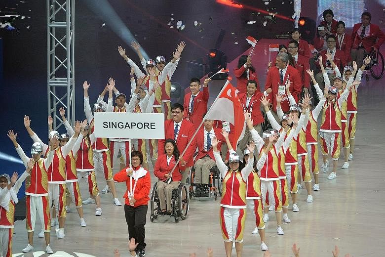 Above left: Last night's show, which featured more than 1,400 performers, who were able-bodied as well as disabled, was rich with the theme of inclusiveness and tolerance. Above right: Team Singapore marching in during last night's opening ceremony a