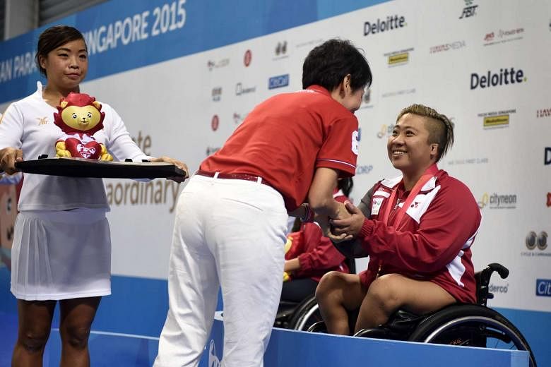 Gold medalist Theresa Goh of Singapore receives her medal from Minister for Culture, Community and Youth Grace Fu after the 100m Freestyle S5 (S1-S5) Timed Final at the 8th ASEAN Para Games held on Dec 4.