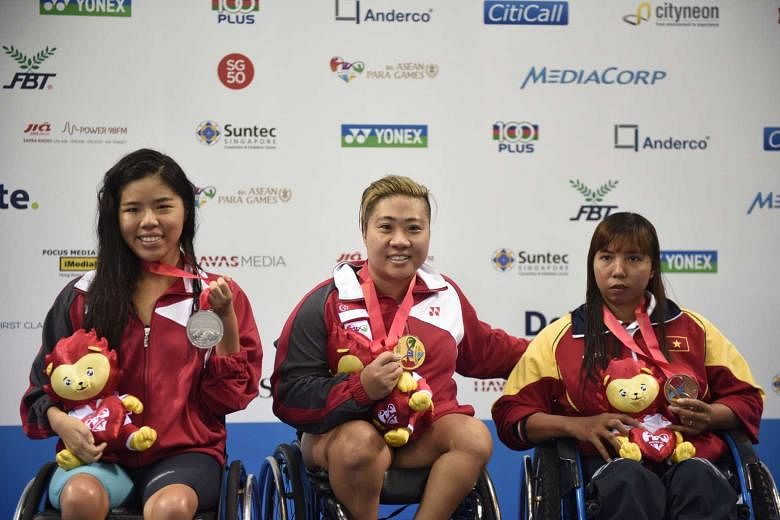Gold medalist Theresa Goh of Singapore, her compatriot and silver medalist Yip Pin Xiu (left) and Danh Thi My Thnah of Vietnam (right) pose for photographs after receiving their medals for the 100m Freestyle S5 (S1-S5) Timed Final at the 8th ASEAN Para Ga