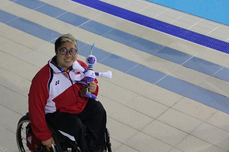  Swimmer Theresa Goh is all smiles as with her bronze medal from the women's 100m freestyle S5 event at the 2014 Asian Para Games in Incheon, South Korea.
