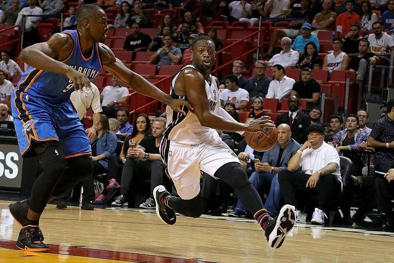 Dwyane Wade (right) accelerates past Oklahoma City Thunder's Serge Ibaka as the 33-year-old taps on his experience to lead Miami Heat out of a tight spot. His two free throws nailed the win with 1.5 seconds left.