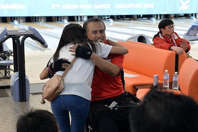 Clockwise from left: Singapore's Anuar Saaid being hugged by his daughter Khairiah Anuar, 25, who was at the Temasek Club to support him. Singapore's Mohamad Ismail Hussain retained his TPB3 crown. Mohamad Rausyan, a Para Games debutant, won the TPB4