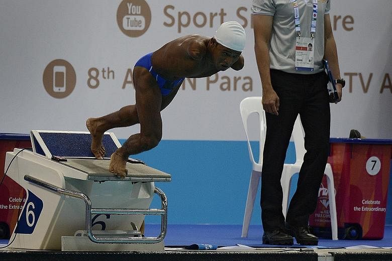 Aung Nyein Oo from Myanmar diving into the pool during the 100m breaststroke SB7 timed final yesterday. The double amputee, 24, set a Games record of 1:32.83. His feat was yet another example of an athlete pushing on with life and finding solutions.