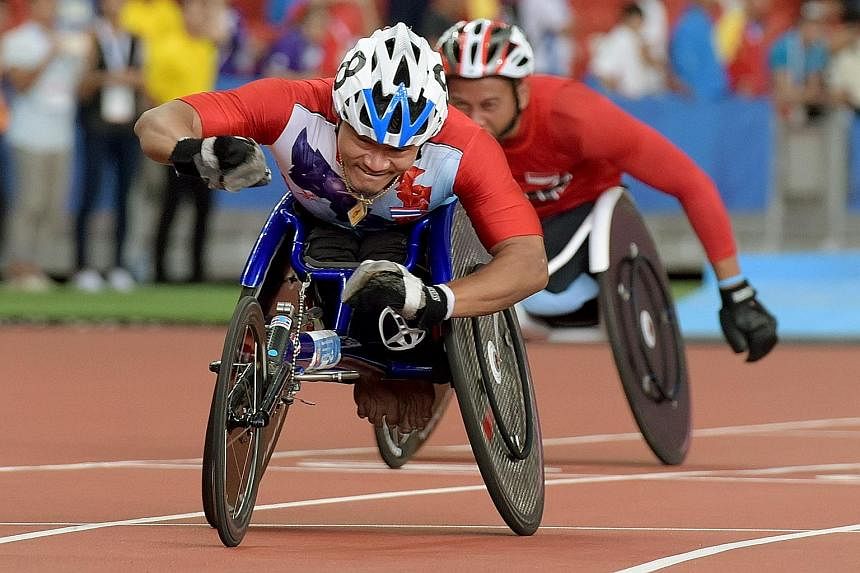 Thailand's Saichon Konjen winning the men's 100m T54 (wheelchair) final in a Games record time of 14.33sec. The 32-year-old is also the favourite to win the 200m and 400m races.