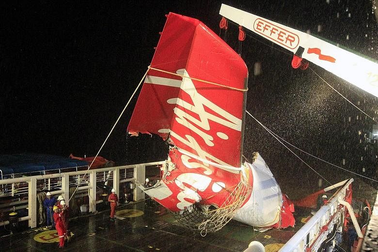 An Indonesian search and rescue crew recovering the tail of Flight QZ8501 from the Java Sea in January. The lawsuit filed by the families claims the plane's rudder trim limiter was "subject to failure".