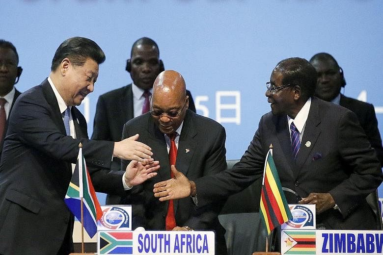 (From left) China's President Xi Jinping with South Africa's President Jacob Zuma and Zimbabwe's President Robert Mugabe - whose government signed 10 economic accords with China this week - during the Forum on China-Africa Cooperation yesterday.
