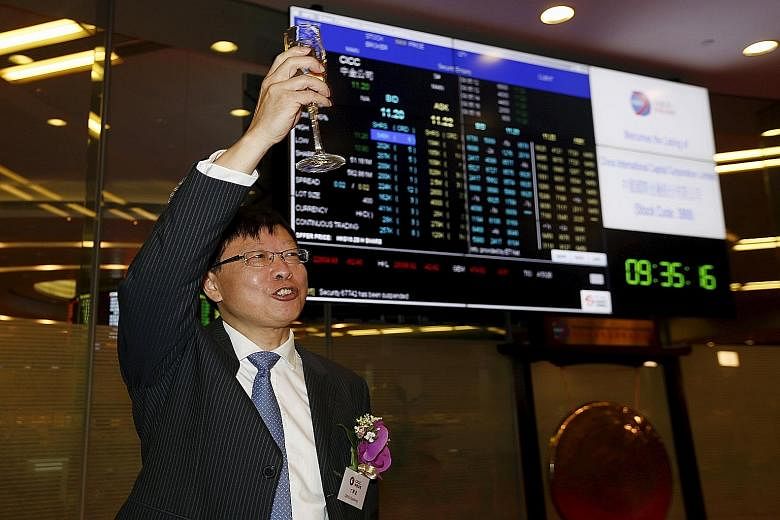 China International Capital Corp (CICC) chairman Ding Xuedong celebrating during the debut of CICC at the Hong Kong stock exchange in Hong Kong on Wednesday.