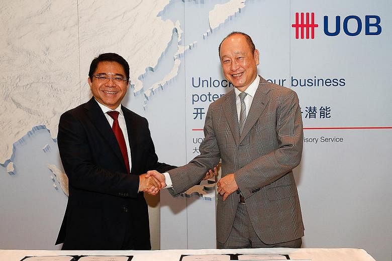 Mr Franky Sibarani (left), chairman of Indonesia's BKPM, with Mr Wee Ee Cheong, deputy chairman and chief executive officer of UOB. The two parties signed an agreement yesterday to boost investment in Indonesia.