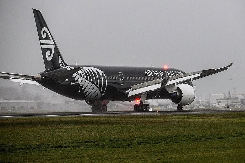 An Air New Zealand plane designed with the New Zealand All Blacks rugby team colours.
