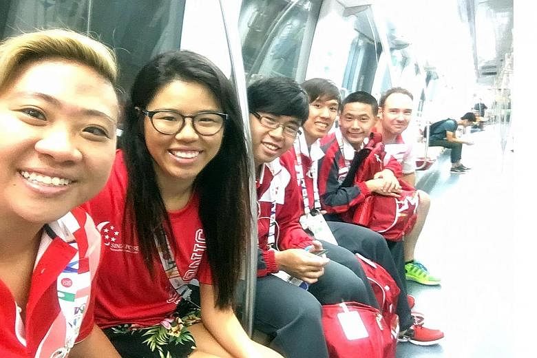 Theresa Goh (left) posing for a photo with Yip Pin Xiu (on her left) and fellow Team Singapore athletes, whom she calls her family.
