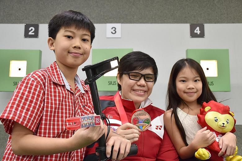 QaneMate is an early Christmas gift from Ian Hao (left) and Ing Le for Neo (centre), who uses a forearm crutch, and it came adorned with an SG50 logo, stickers of Santa Clauses and Christmas trees.