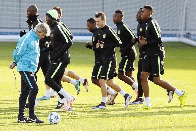 Manuel Pellegrini supervising a Manchester City training session yesterday. The Chilean manager will have influential midfielder Yaya Toure back in the squad for today's clash with Borussia Moenchengladbach.