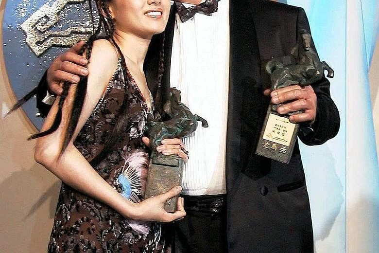 Taiwanese actor Ko Chun-hsiung (left) with Hong Kong actress Rachel Lee (far left) at the 1999 Golden Horse Awards ceremony in Taipei.
