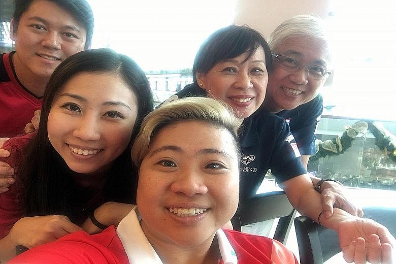 Theresa Goh (front) and family at Trung Nguyen Coffee cafe at Marina Bay Sands yesterday. From left are brother-in-law Kenny Han, sister Marisa, mother Rose and father Bernard.
