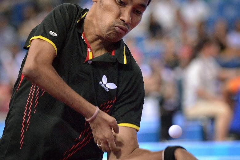David Jacobs playing a shot during the current Asean Para Games in Singapore. The Indonesian has already won two golds and is the favourite to land the singles title too tonight.