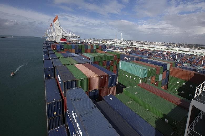 Containers (right) aboard the CMA CGM Bougainville ship in the port of Le Havre, France. Mr Saade said CMA CGM will establish its regional head office in Singapore and use the country as a key hub in Asia, noting that "Singapore and the region are ve