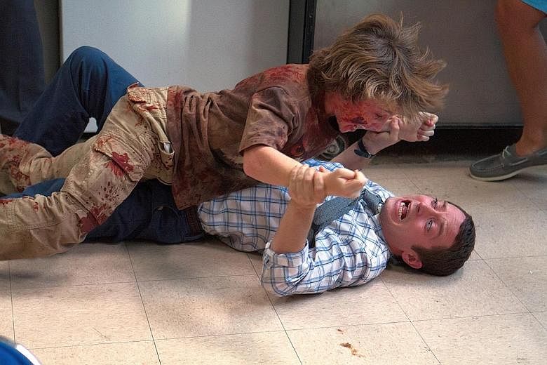 Elijah Wood (above, on floor) fights off infected children in Cooties.