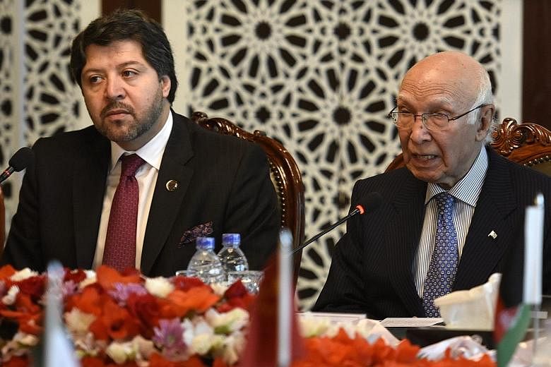 Afghan Deputy Foreign Minister Hekmat Khalil Karzai (left) and Pakistan's National Security Adviser Sartaj Aziz at the Heart of Asia conference yesterday. Warmer ties between the countries are far off.