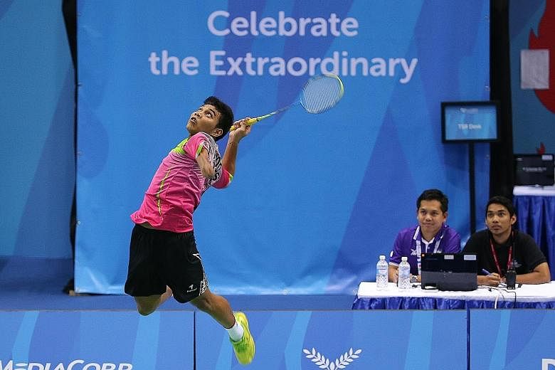 Suryo Nugroho leaping to unleash a smash during the badminton team final against Malaysia. The Indonesian beat world No. 1 Cheah Liek Hou of Malaysia to claim the SU5 men's singles title yesterday.