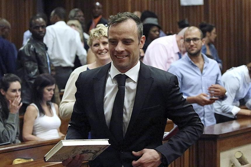 Pistorius leaving the courtroom in Pretoria after he was granted bail yesterday. He will appeal against his conviction for the murder of his girlfriend, and could face a 15-year jail term if that fails.