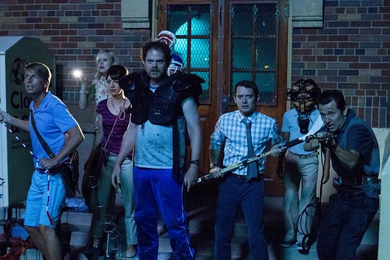 Elijah Wood (second from right, with tie) stars in Cooties, a film about child zombies attacking a school. He is joined by (front row, from far left) Jack McBrayer, Rainn Wilson and Leigh Whannell.