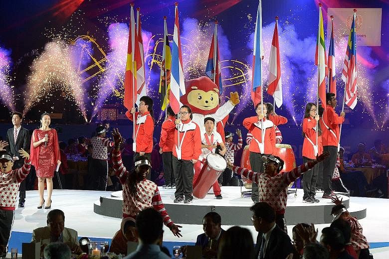 The flags of the 10 competing Asean nations being displayed during the closing ceremony of the 8th Asean Para Games last night. Close to 100,000 spectators attended the week-long event hosted by Singapore, which achieved a record haul of 24 golds.