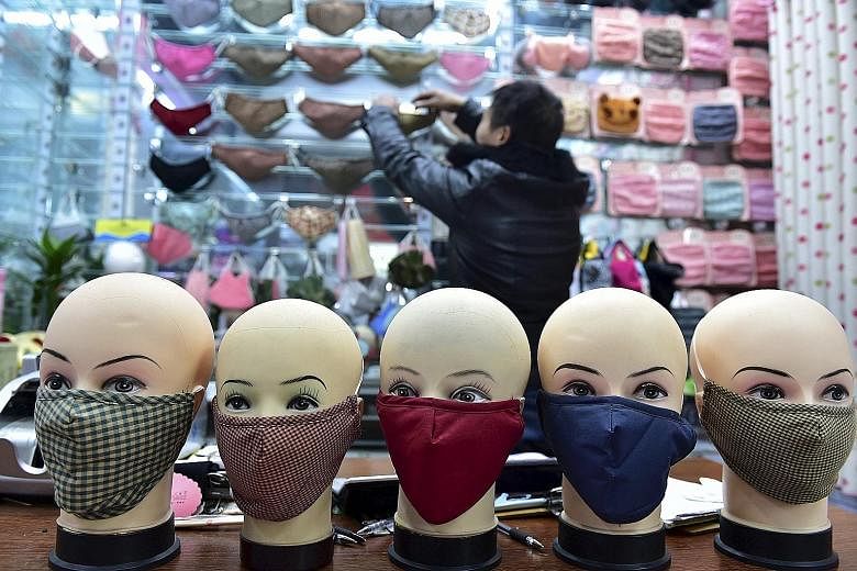 Masks on sale at a shopping mall in Yiwu, Zhejiang province, on Monday. Pollution red alerts have been raised in more cities. Dingzhou and Xinji, two cities in Hebei province, which surrounds Beijing, issued their first red alerts even as the air in 