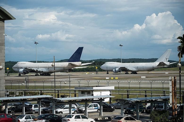 Two of the three Boeing 747-200F planes parked on the tarmac at Kuala Lumpur International Airport on Tuesday.