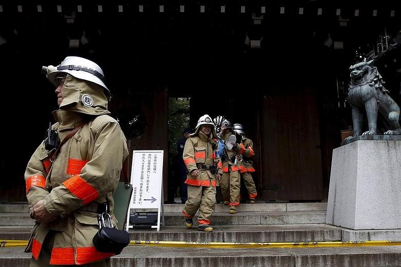Firemen at the Yasukuni Shrine after a blast on its premises in Tokyo, Japan, on Nov 23. The explosion happened in a men's washroom. No one was hurt.