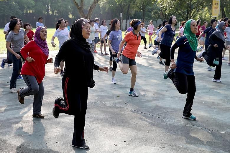 Residents participating in a Bokwa Fitness routine in Choa Chu Kang Park. The cardio-intensive workout, in which participants draw letters of the alphabet and numbers with their feet, is just one of around 16 different types of exercise classes resid