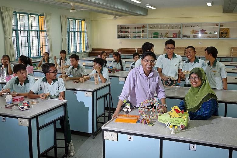Dr Muhammad Nazir Amir, who won the President's Award for Teachers last year, says he is not taking part in the competition for personal reasons. He is seen here in the school's laboratory with laboratory support officer Nor Aini Abdullah and some of