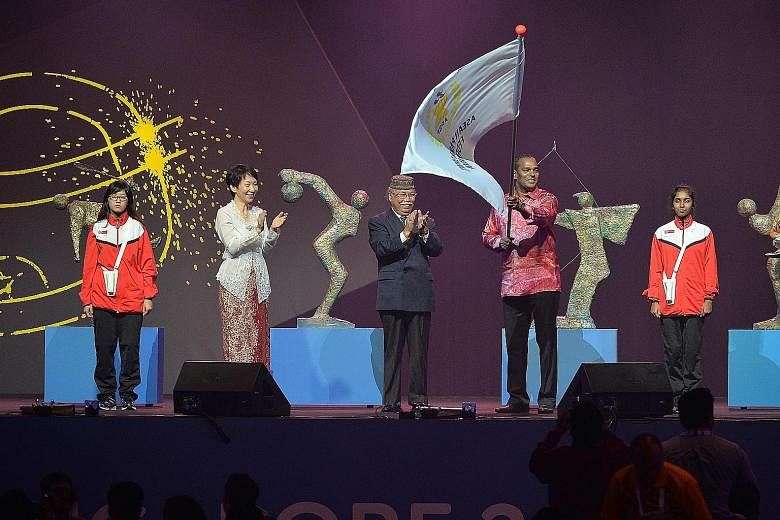 Clockwise, from above: A performance by Malaysia, the country that will host the next edition in Kuala Lumpur in 2017; a Singapore troupe takes the stage; and the ceremonial handover of duties is marked by Minister for Culture, Community and Youth Gr