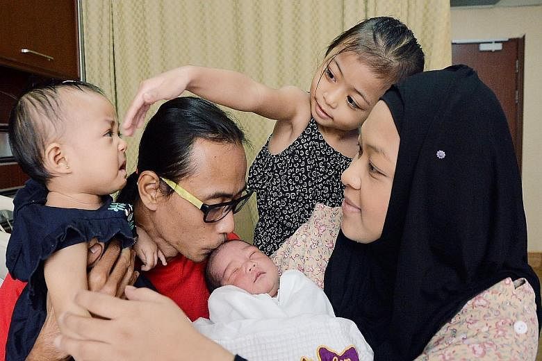 Madam Lydiawati gave birth to Mohammad Rifly Asyraaf on Monday, 10 months after younger daughter A'lya Aamily Delisha was born. With them are Mr Mohamad Ali and older daughter A'lya Mayli Shazya.