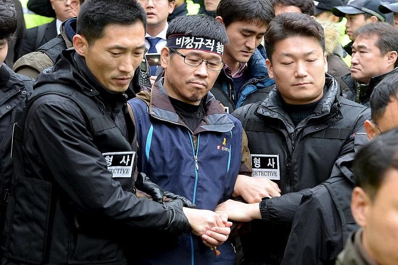 Han Sang Gyun (centre), head of one of South Korea's two main labour groups, holed up in a Buddhist temple for almost four weeks to avoid arrest for organising an anti-government protest last month.