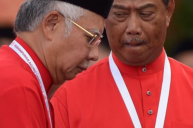 Prime Minister Najib Razak (left) and Umno deputy president Muhyiddin Yassin at the party's annual congress in Kuala Lumpur yesterday. Mr Najib has faced calls to resign for his handling of debt-burdened state investment firm 1MDB. There are also cal