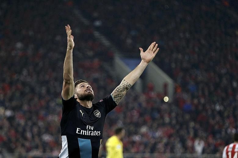 Olivier Giroud celebrating after scoring the second goal against Olympiakos. The Frenchman recorded his first hat-trick for Arsenal in their 3-0 win and also set a target to reach at least the Champions League quarter-finals.