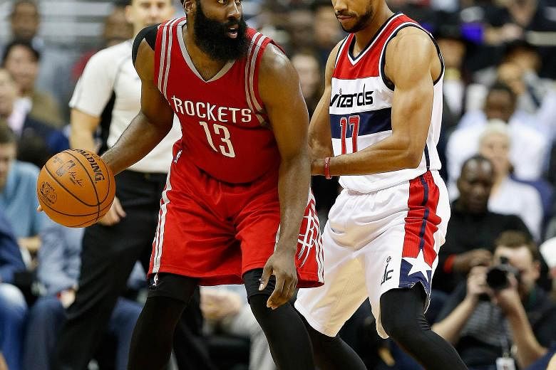 James Harden (left) of the Rockets working the ball against Garrett Temple of the Wizards during the second half in Washington. The visitors won 109-103, their fourth triumph in their last five games.