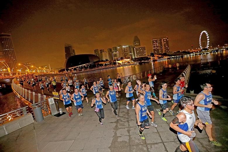Participants at this year's ST Run passing city landmarks such as the Esplanade and Singapore Flyer. Next year's event will take runners past more of the stunning sights around the Marina Bay area.