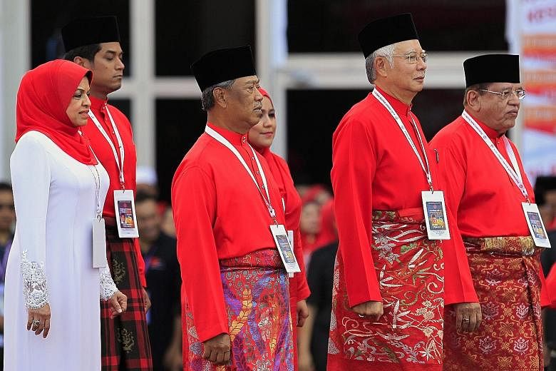 Malaysian PM Najib Razak (centre) with his party deputy Muhyiddin Yassin (left) and secretary-general Tengku Adnan Tengku Mansor at the Umno general assembly's opening ceremony on Thursday.