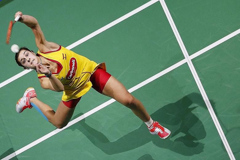 Spain's Carolina Marin (right) during her loss to Japan's Nozomi Okuhara in their women's singles match at the BWF Dubai World Superseries Finals tournament.