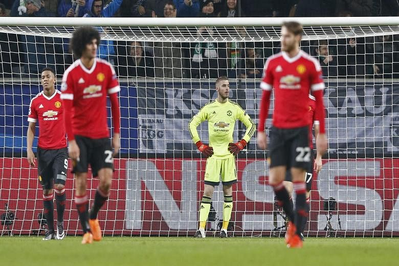 Manchester United's Marouane Fellaini, David de Gea and Nick Powell look dejected after Naldo scored the third goal in Wolfsburg's 3-2 win against Manchester United in the Champions League game on Tuesday.