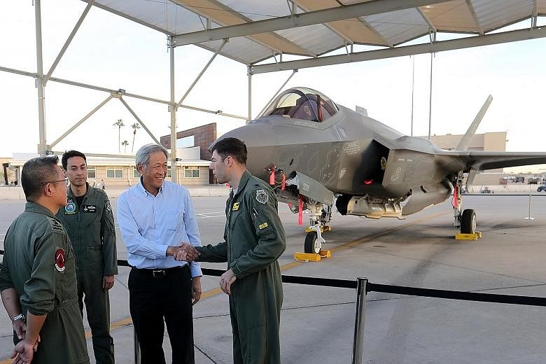Dr Ng Eng Hen with Lieutenant-Colonel Michael Gette, who commands the 61st Fighter Squadron, during the Defence Minister's visit to the Luke Air Force Base yesterday.