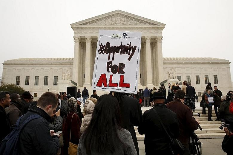 Demonstrators gathering outside the Supreme Court in Washington on Wednesday as the case on the University of Texas at Austin's affirmative action policy for admissions was being heard.