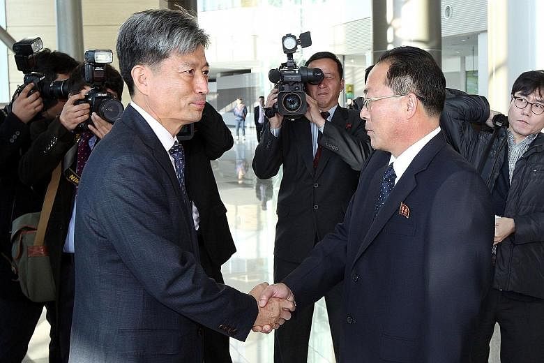 South Korea's Vice-Unification Minister Hwang Boo Gi (left) shaking hands with his counterpart from the North, Mr Jon Jong Su, before their meeting in Kaesong yesterday.