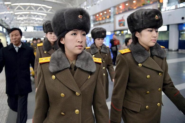 Some members of North Korea's all-female Moranbong Band arriving at Beijing International Airport yesterday for their flight home. The band had abruptly cancelled its concert in the Chinese capital.