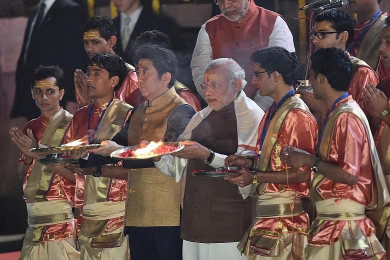 Japanese Prime Minister Shinzo Abe (centre left) and his Indian counterpart Narendra Modi (centre right) during the evening Aarti ritual on the banks of the River Ganges at Varanasi yesterday.