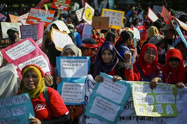 Migrant workers and domestic helpers from around Asia taking part in a protest yesterday in Taipei, near the Presidential Office Building. More than 1,000 protesters from Indonesia, the Philippines, Thailand and Vietnam demanded justice, equality and