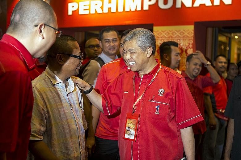 Malaysia's Deputy Prime Minister Ahmad Zahid Hamidi (right) greeting supporters as he arrived for the Umno General Assembly at the Putra World Trade Centre in Kuala Lumpur on Tuesday. Prime Minister Najib Razak was in the spotlight but the man by his