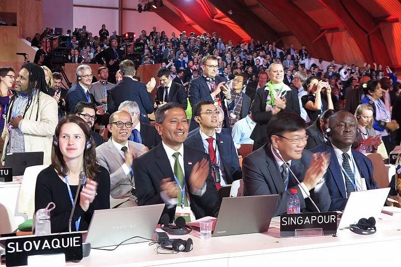 Foreign Minister Vivian Balakrishnan (foreground, second from left) at the World Climate Change Conference 2015 in Paris. He acknowledged that the deal was not perfect but, for the first time, the world has a climate pact in which all nations would p